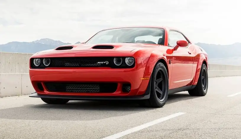 Bright orange red 2021 Dodge Challenger SRT Super Stock muscle car on desert highway