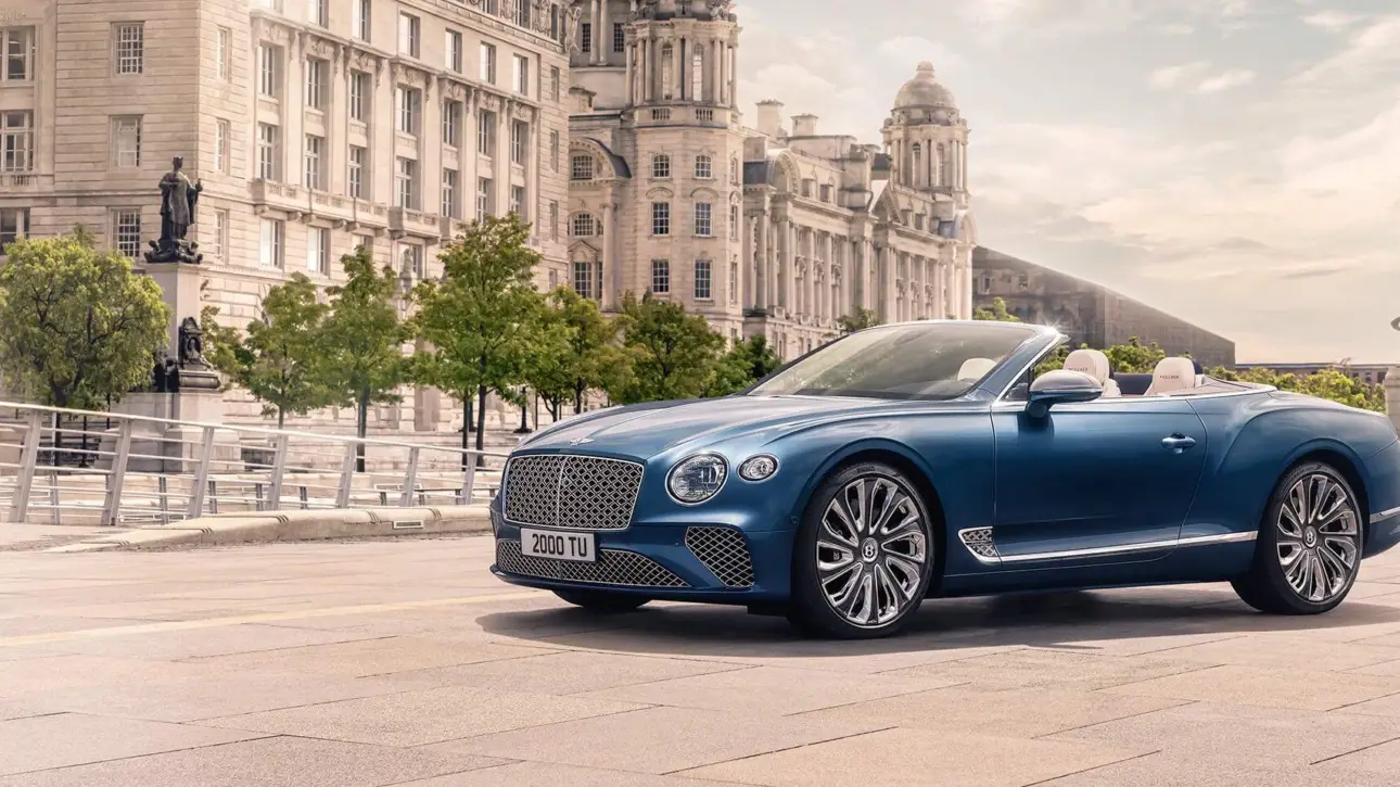 Blue Bentley Continental GTC Mulliner luxury convertible in elegant European city square with classical architecture