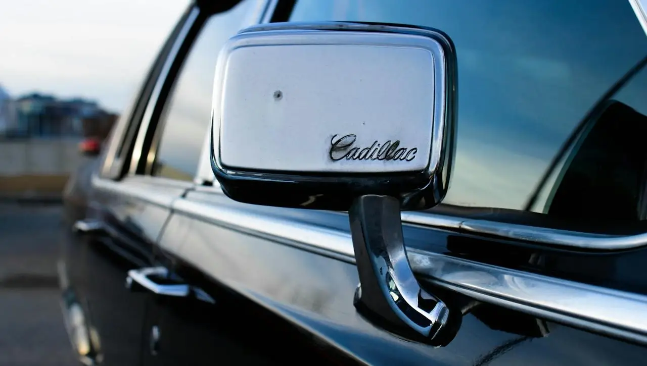 Cadillac Escalade side mirror and door handle close-up detail showcasing luxury vehicle craftsmanship