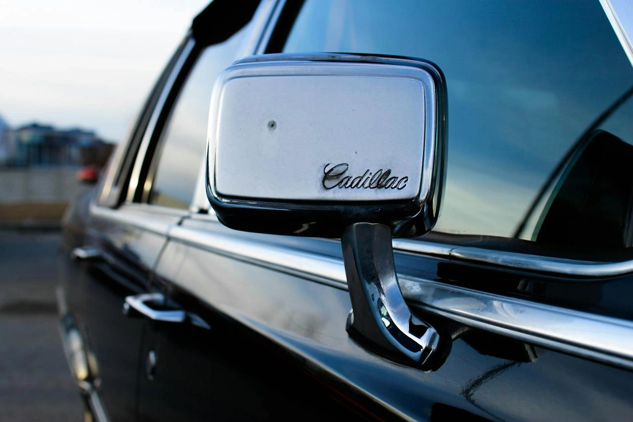 Cadillac Escalade side mirror and door handle close-up detail showcasing luxury vehicle craftsmanship