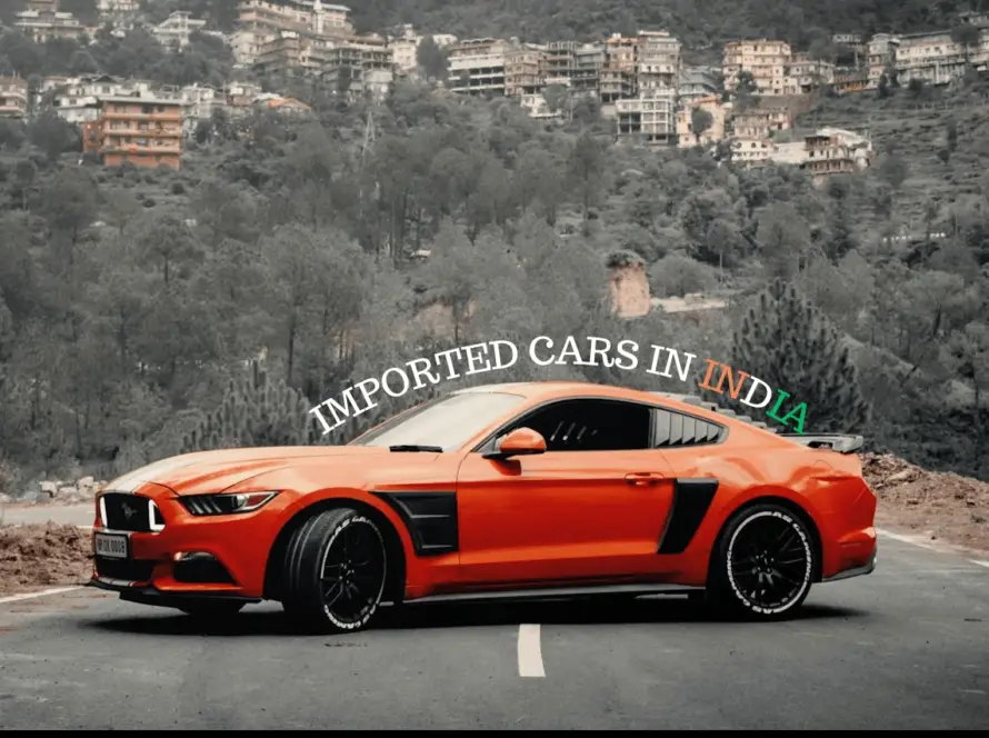 Orange Ford Mustang sports car on mountain road demonstrating how to import USA cars in India with Daytona Exotics