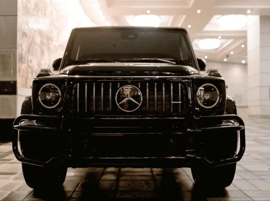 Black Mercedes-AMG G-Wagon luxury SUV front view in showroom from imported cars lineup at Daytona Exotics