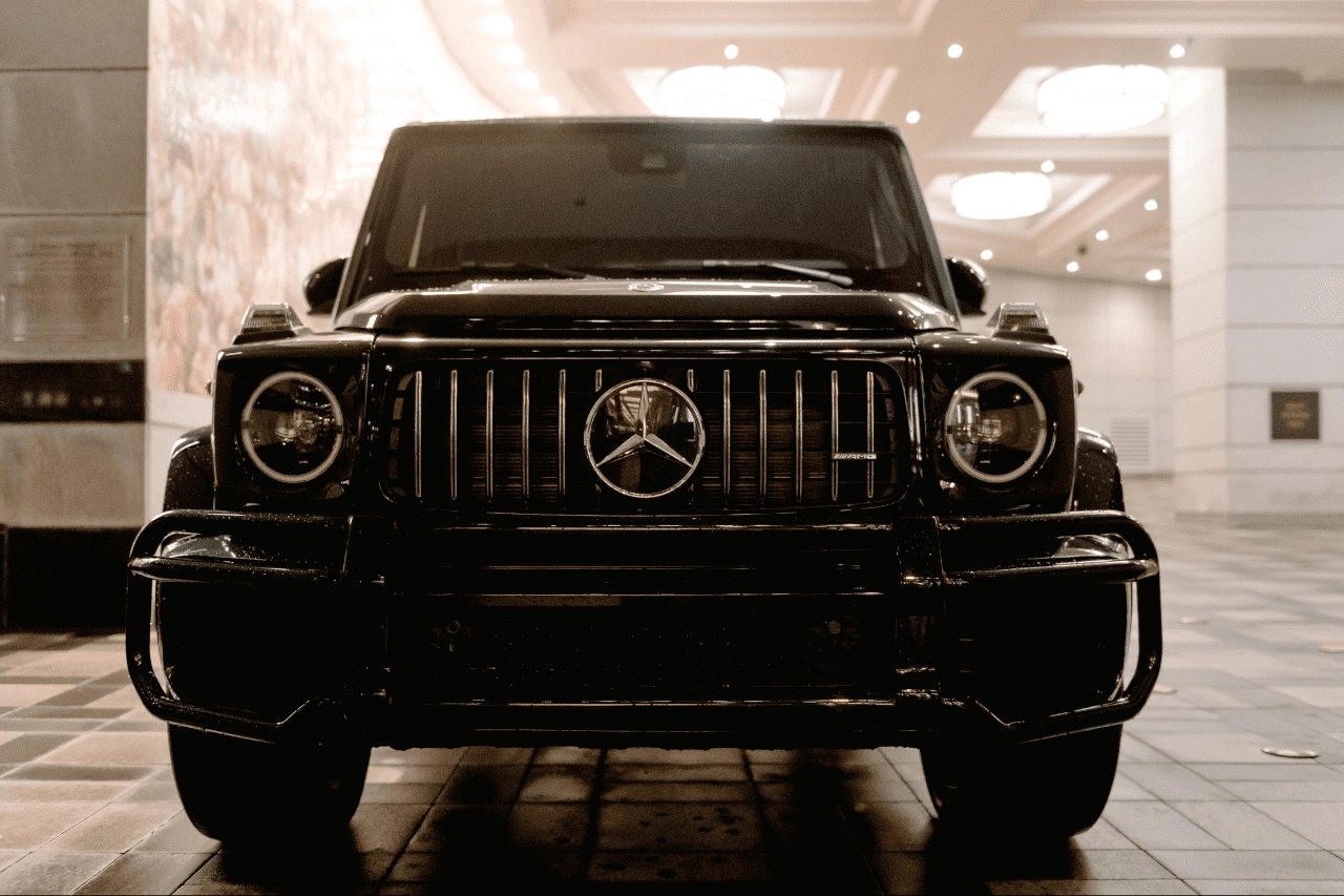 Black Mercedes-AMG G-Wagon luxury SUV front view in showroom from imported cars lineup at Daytona Exotics