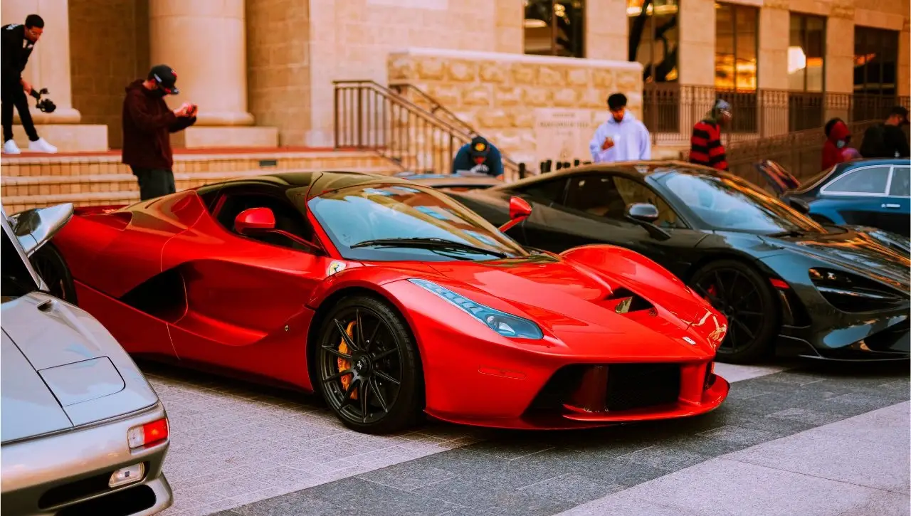 Red Ferrari and exotic supercars displayed in luxury showroom showcasing best imported cars in India for sale