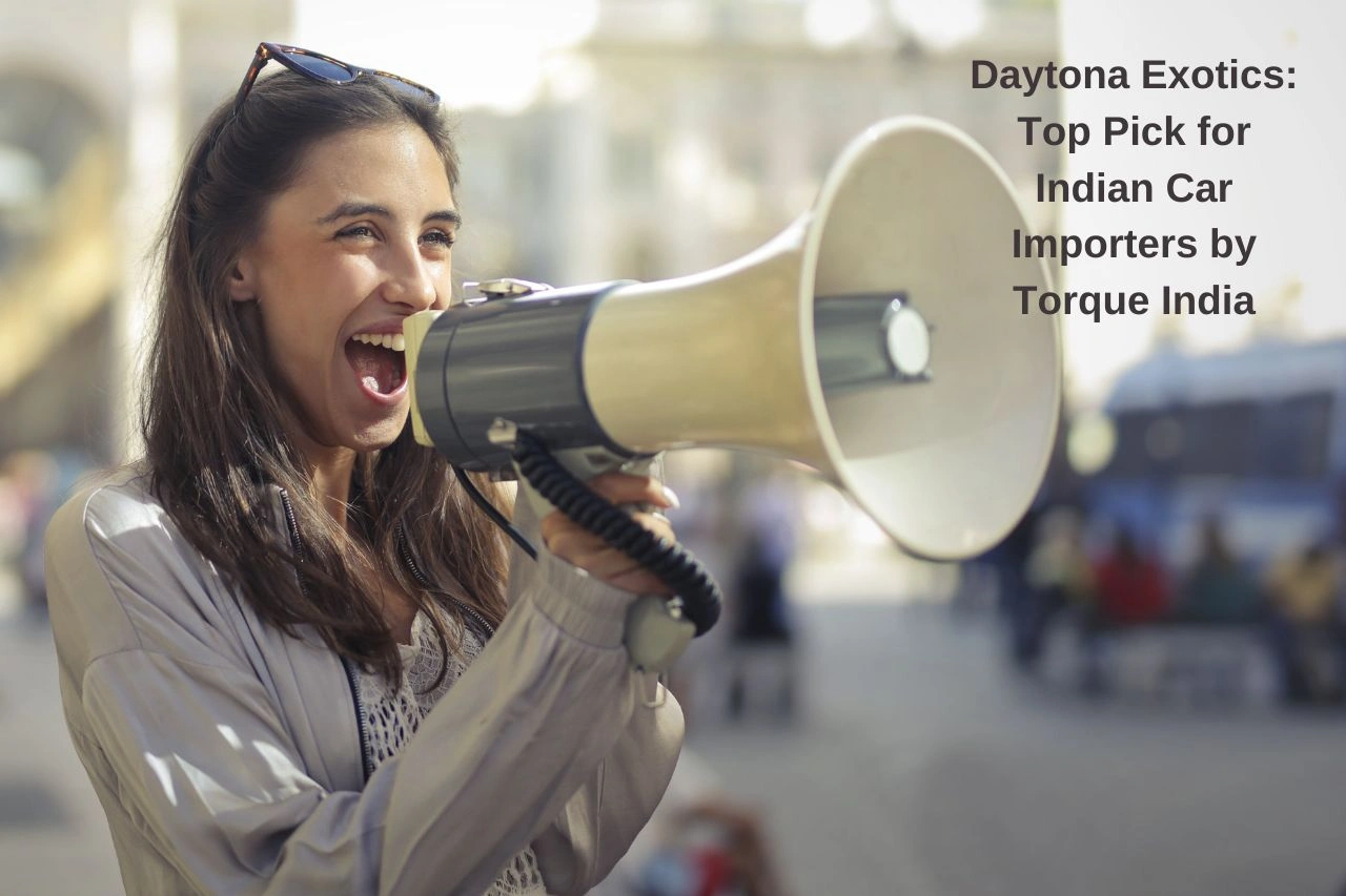 Woman announcing with megaphone about Daytona Exotics recognition as top car importer by Torque India