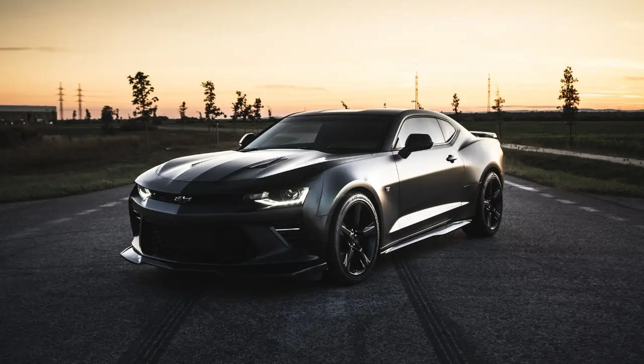 Black Chevrolet Camaro V8 muscle car at sunset representing America's dream car in India