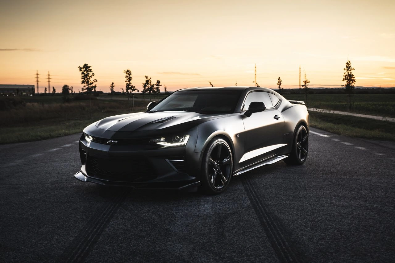 Black Chevrolet Camaro V8 muscle car at sunset representing America's dream car in India