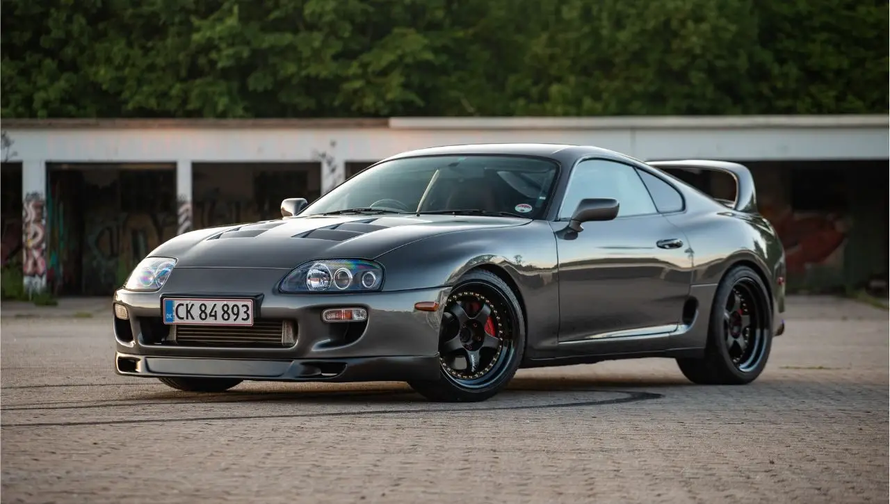 Silver Toyota Supra Japanese sports car parked outside garage exploring import of Japanese cars to India