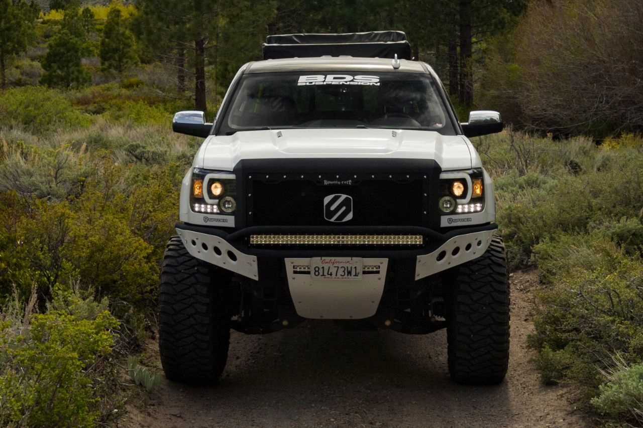 White pickup truck with bull bars and off-road modifications exploring purpose of bull bars on trucks