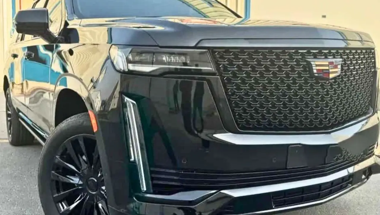 Cadillac Escalade front grille and headlight close-up representing symbol of luxury and power in SUV segment