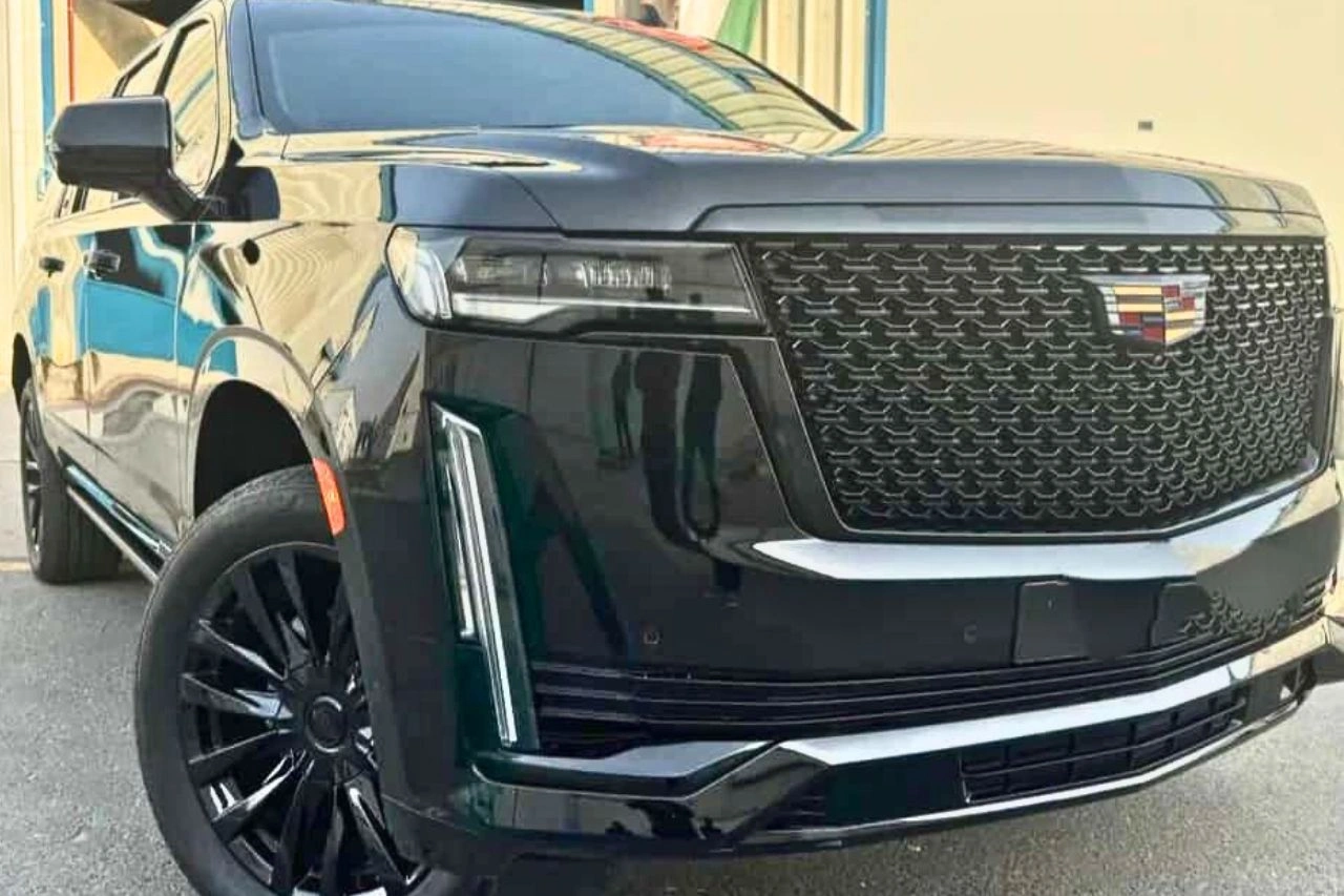 Cadillac Escalade front grille and headlight close-up representing symbol of luxury and power in SUV segment