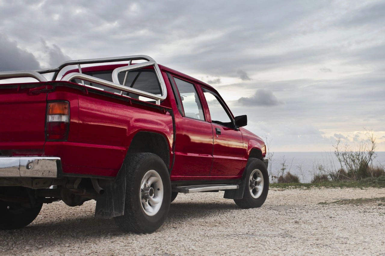Red pickup truck with roll cage and lift kit modifications showcasing ultimate guide to truck customization