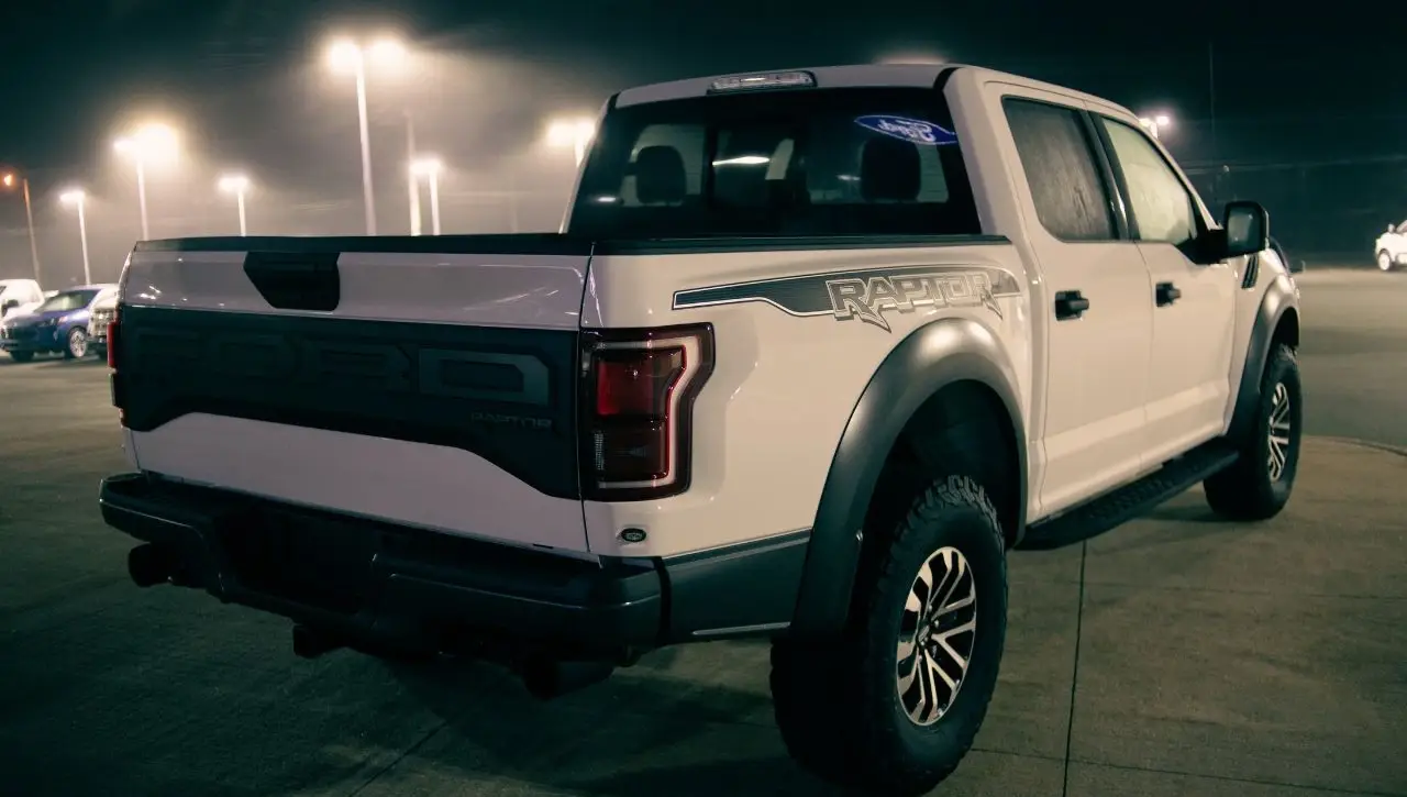 White pickup truck parked at night showcasing ultimate truck upgrades available with Daytona Exotics