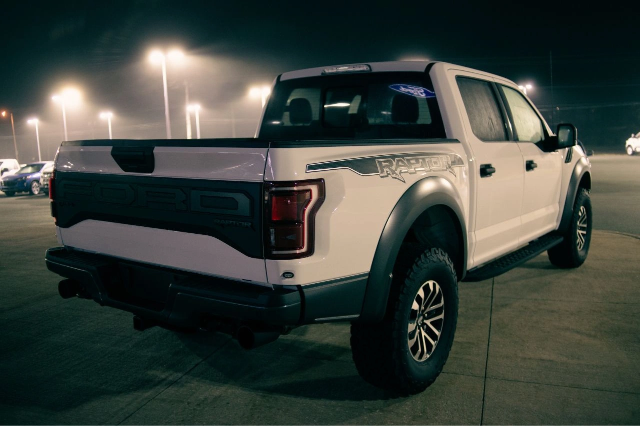 White pickup truck parked at night showcasing ultimate truck upgrades available with Daytona Exotics