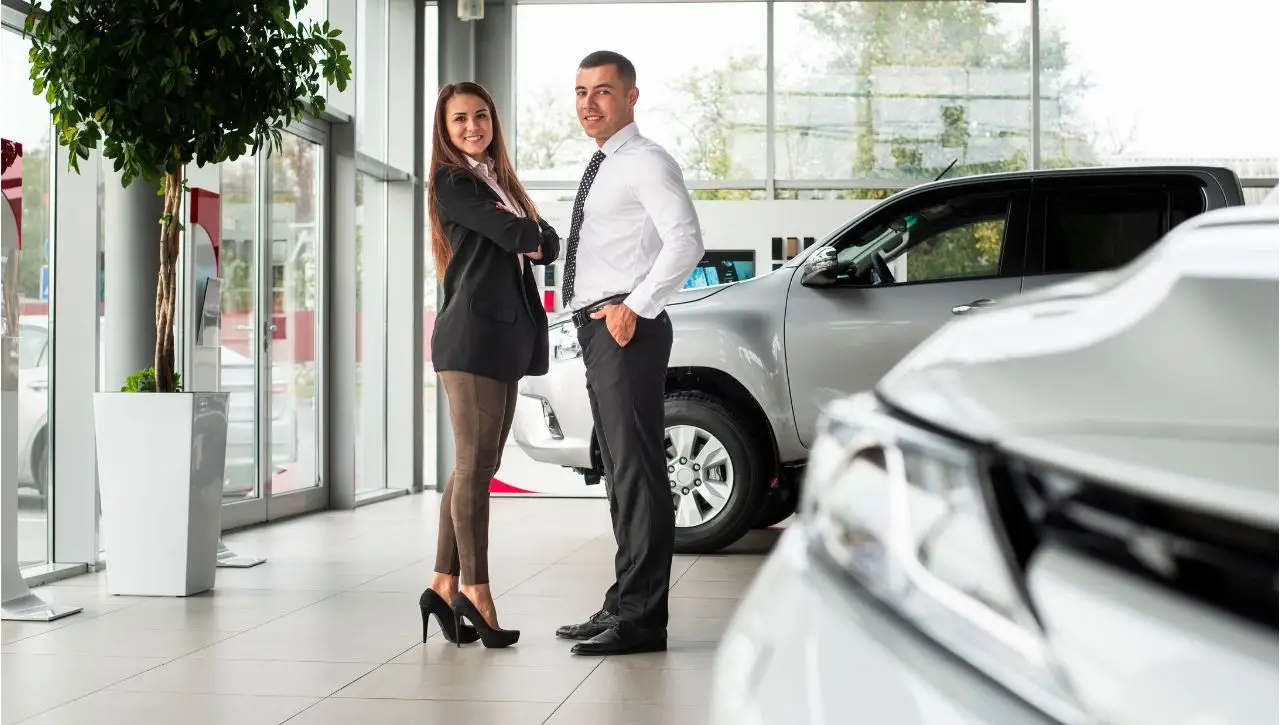 Professional couple at Daytona Exotics luxury car dealership showroom showcasing top reasons to choose as trusted dealer in Delhi