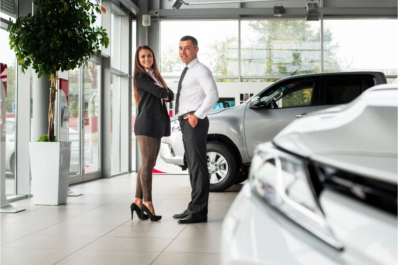 Professional couple at Daytona Exotics luxury car dealership showroom showcasing top reasons to choose as trusted dealer in Delhi