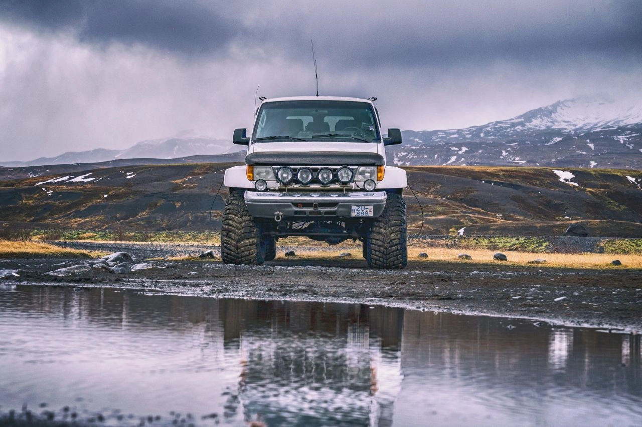 White Toyota Land Cruiser LC76 Station Wagon on Iceland terrain showcasing 2024 powerhouse ready for export to India