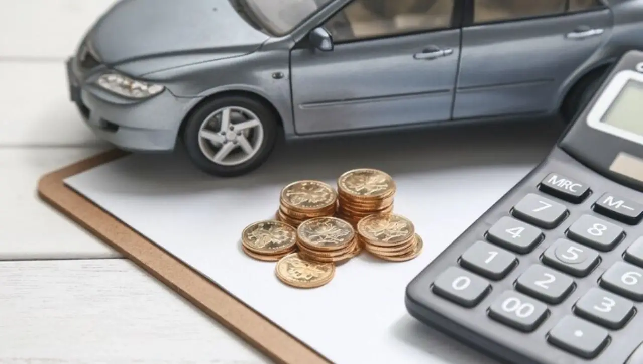 Calculator and coins with car model illustrating luxury car taxes in India and how much it really costs