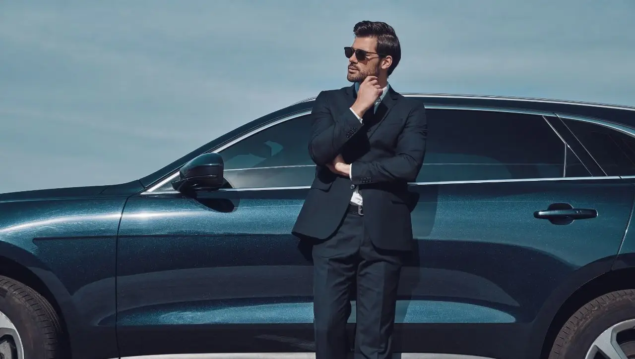 Man in suit beside blue luxury SUV best luxury SUVs in India top picks for comfort and performance in 2025