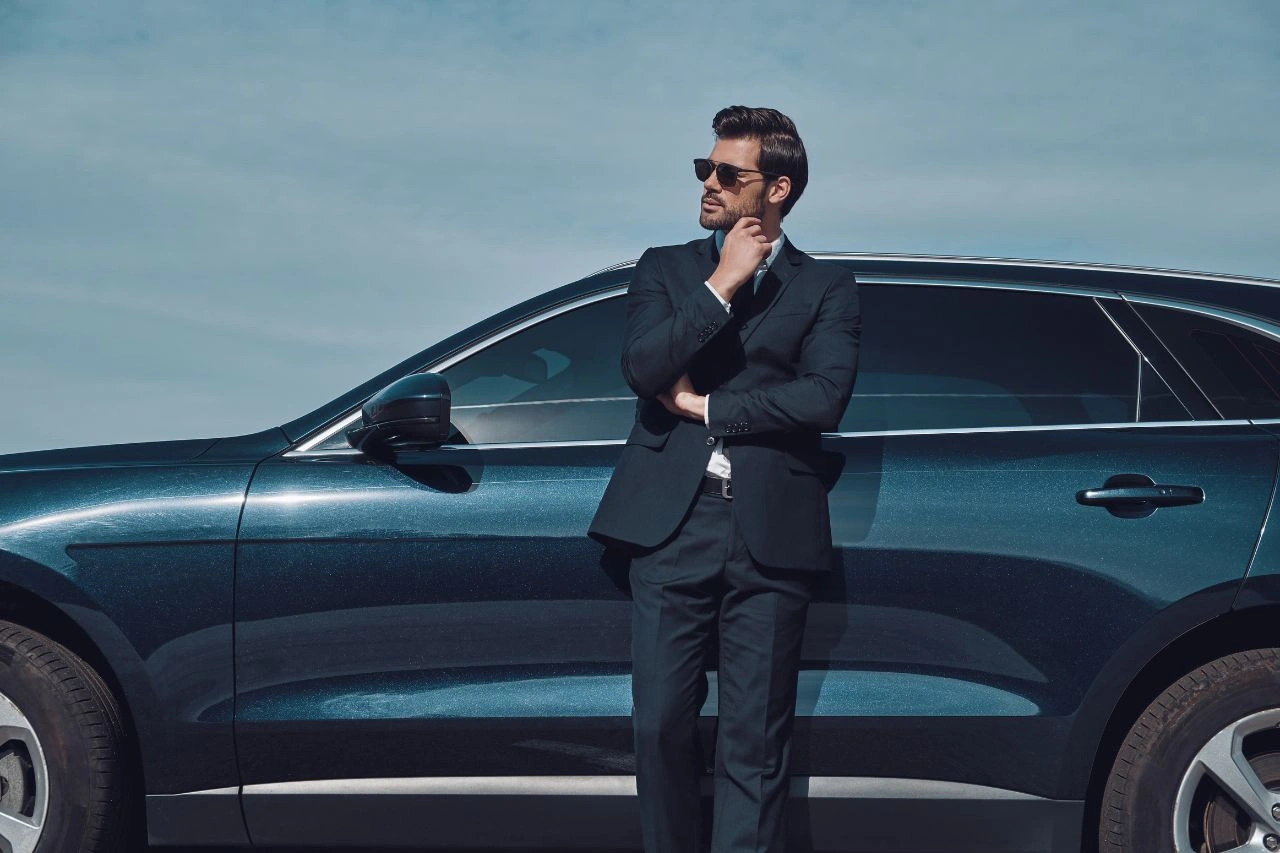 Man in suit beside blue luxury SUV best luxury SUVs in India top picks for comfort and performance in 2025