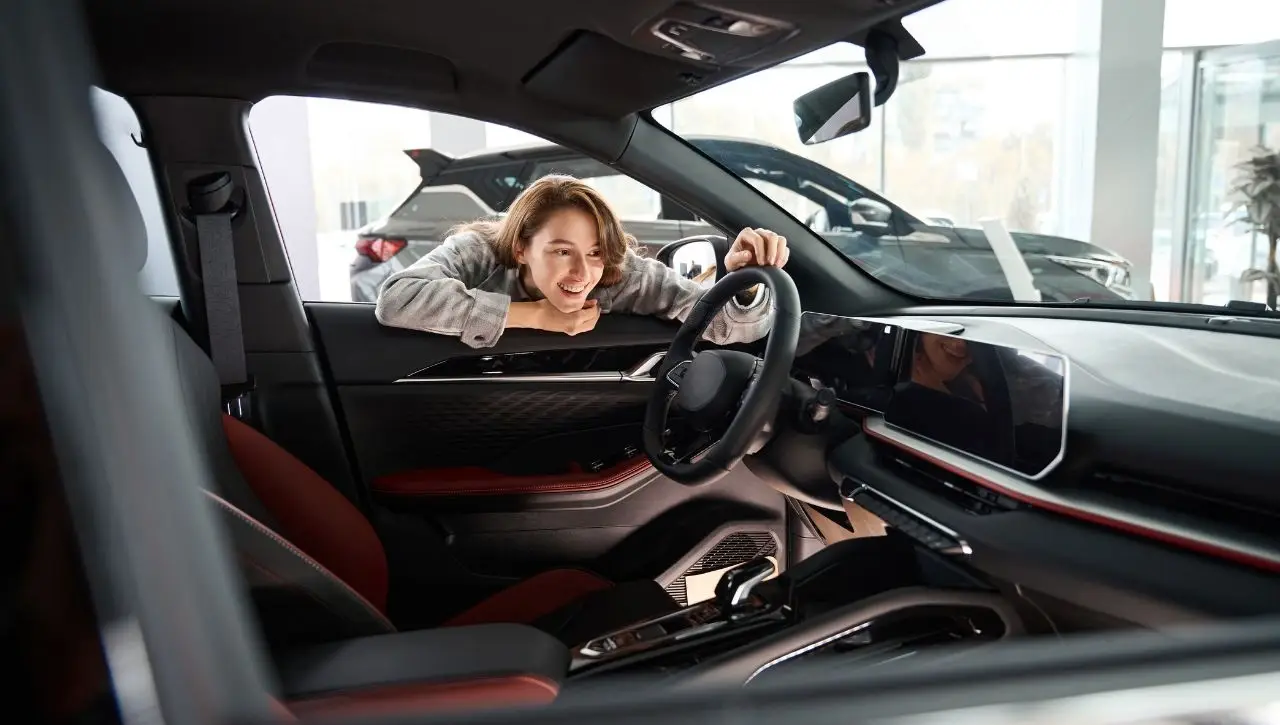 Woman smiling in exotic supercar interior with red leather seats ultimate guide to owning supercar in India