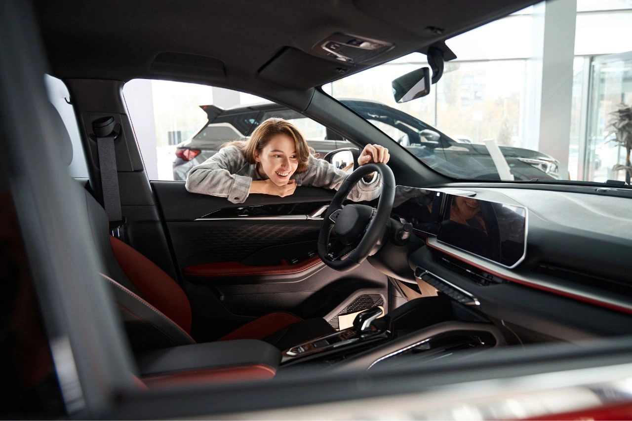 Woman smiling in exotic supercar interior with red leather seats ultimate guide to owning supercar in India