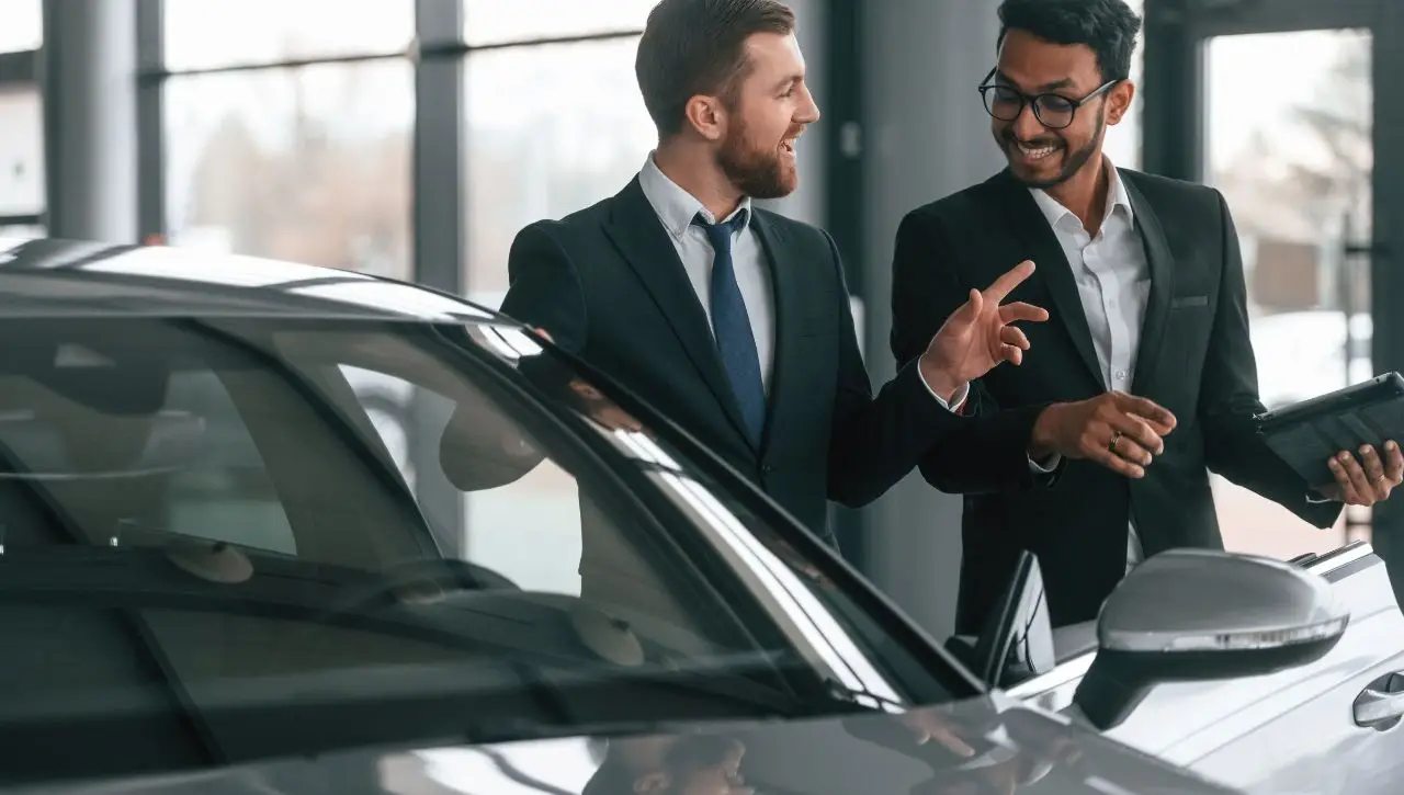 Two professional men discussing imported car dealership options where to buy your dream car in India