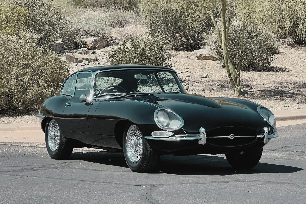 Dark green Jaguar E-Type coupe classic sports car in desert 1965-75 roadster guide which style suits you best